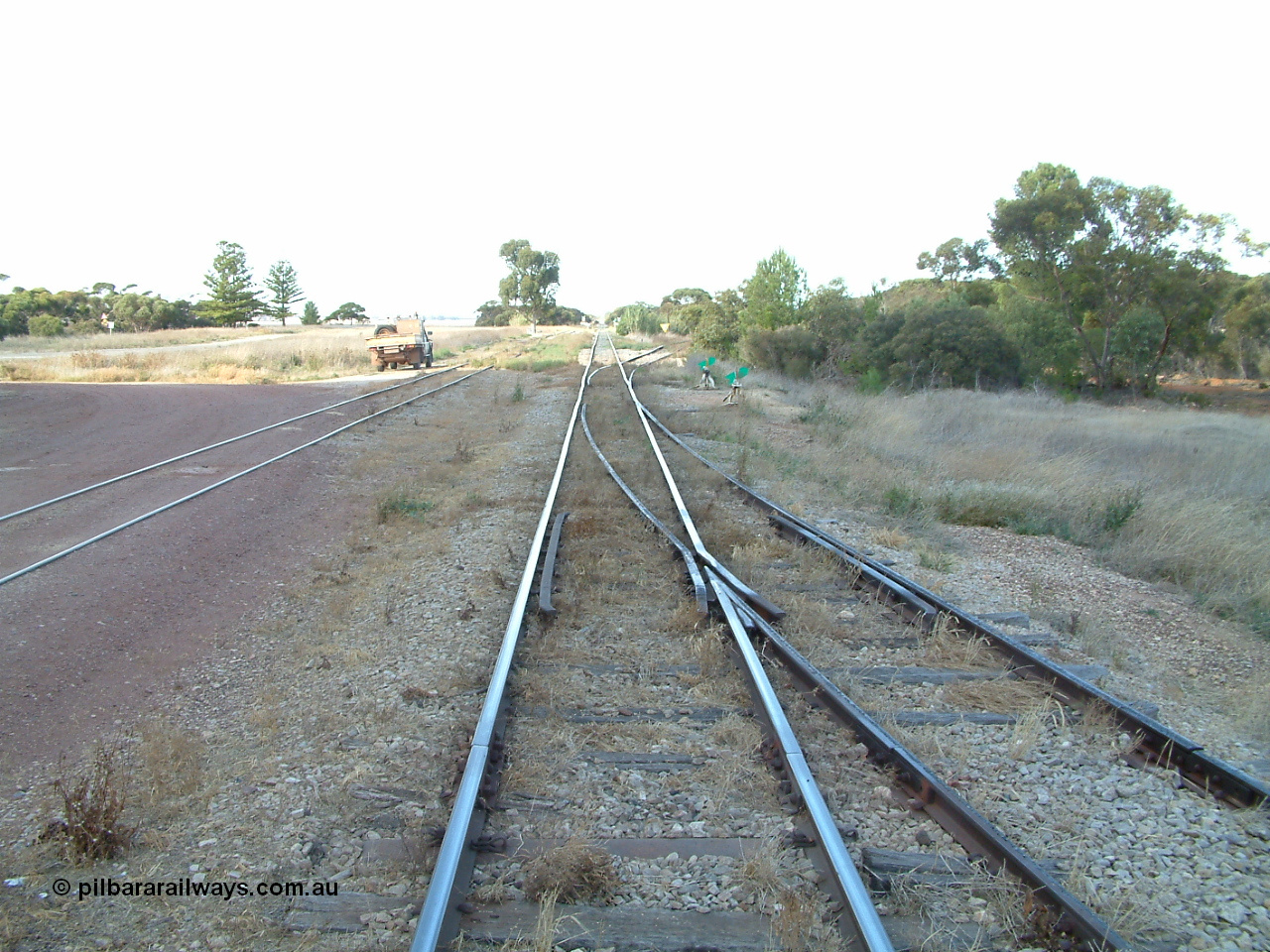 030406 092548
Yeelanna, yard view looking south along the mainline, with points and converging track from the station siding visible on the right, and the points, lever and indicator for the diverging line to Kapinnie and former Mount Hope branch curving to the right. 6th April 2003.
