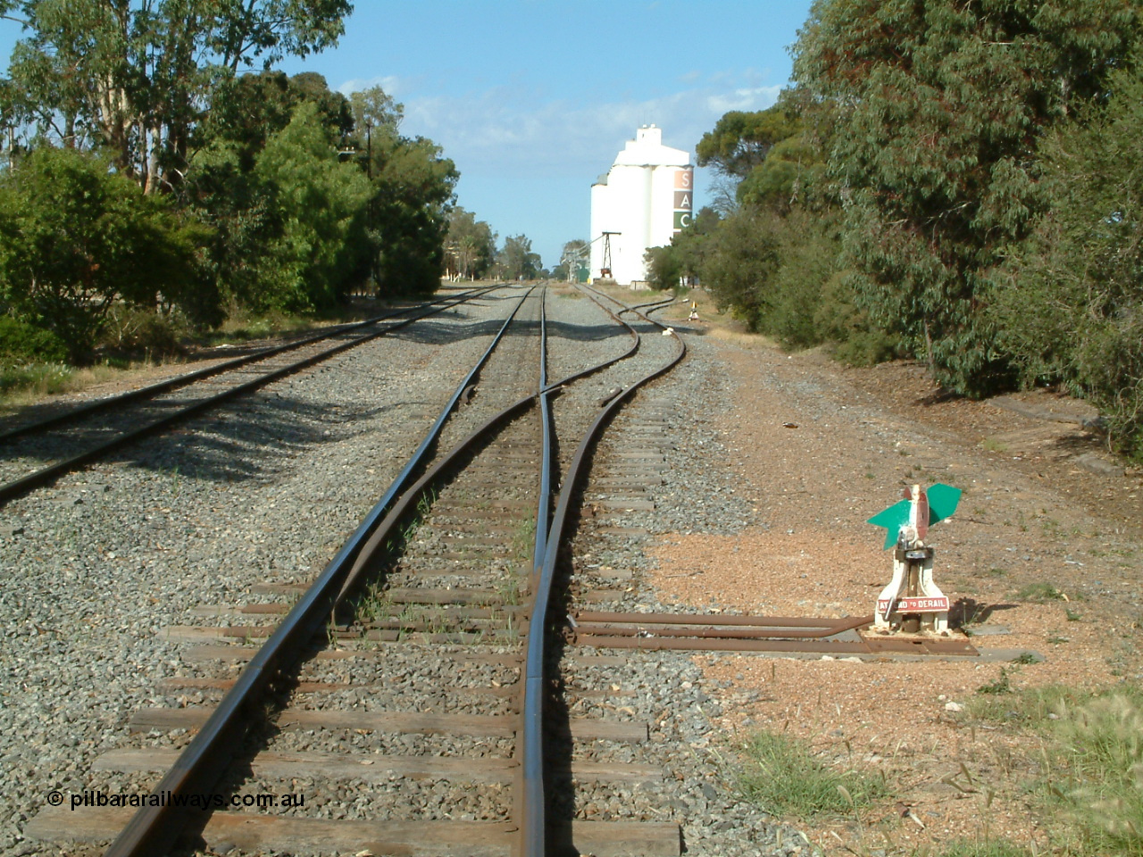 030406 094438
Cummins, yard view looking south along the mainline with the points, lever and indicator for the grain siding, then the same for the goods loading ramp, the Buckleboo line - siding is on the left. 6th April 2003.
