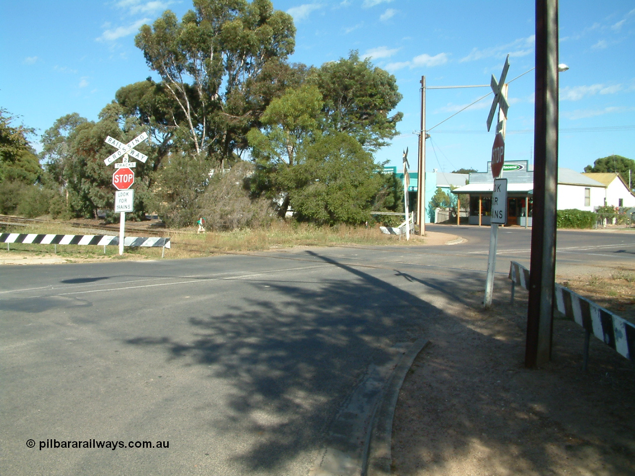 030406 094958
Cummins, Hall Street grade crossing, looking south, point lever and indicator visible for the grain siding off the mainline, branch line to Buckleboo is the near track. 6th April 2003.
