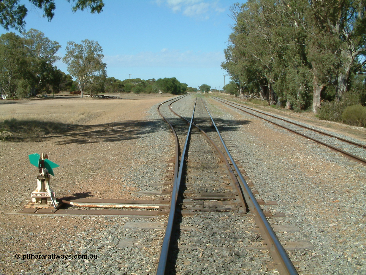 030406 100148
Cummins, track view looking south along the mainline, points, indicator and lever for the grain bunker loading - unloading site which is behind the trees to the left, goods and grain siding on the right. 6th April 2003.
