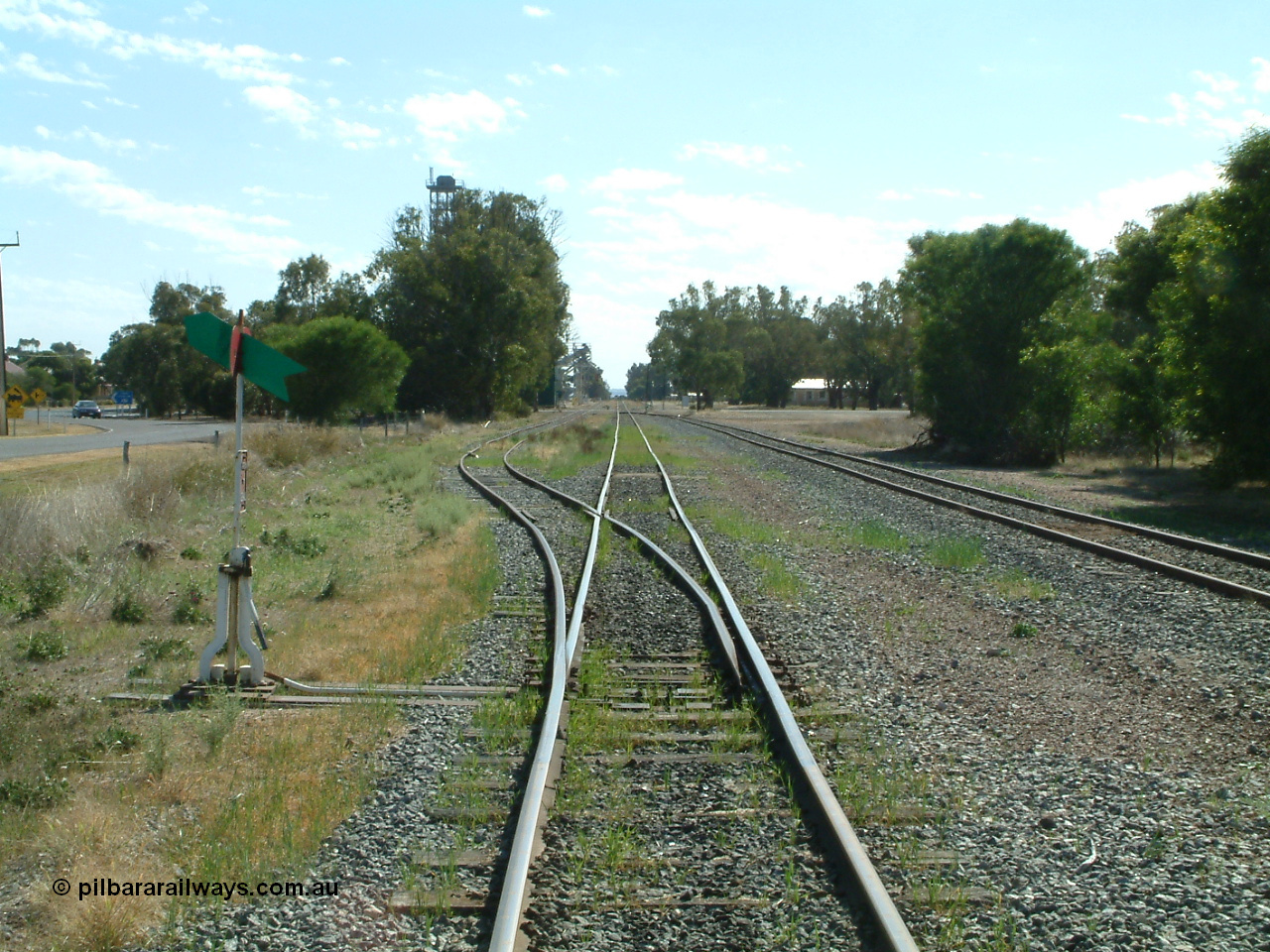 030406 100330
Cummins, yard overview looking north from the south end of the yard down the mainline. Points, lever and indicator for the goods and grain siding, the tracks on the right run behind the camera to the grain bunker loading - unloading site. 6th April 2003.
