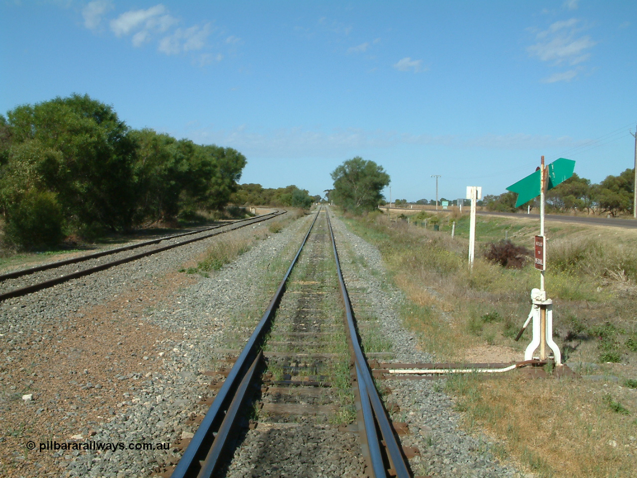 030406 100404
Cummins, track view looking south, points, lever and indicator for the goods and grain siding, on the left the grain bunker loading - unloading site track can be seen curving away to the left. The Todd Highway is at the far right. 6th April 2003.
