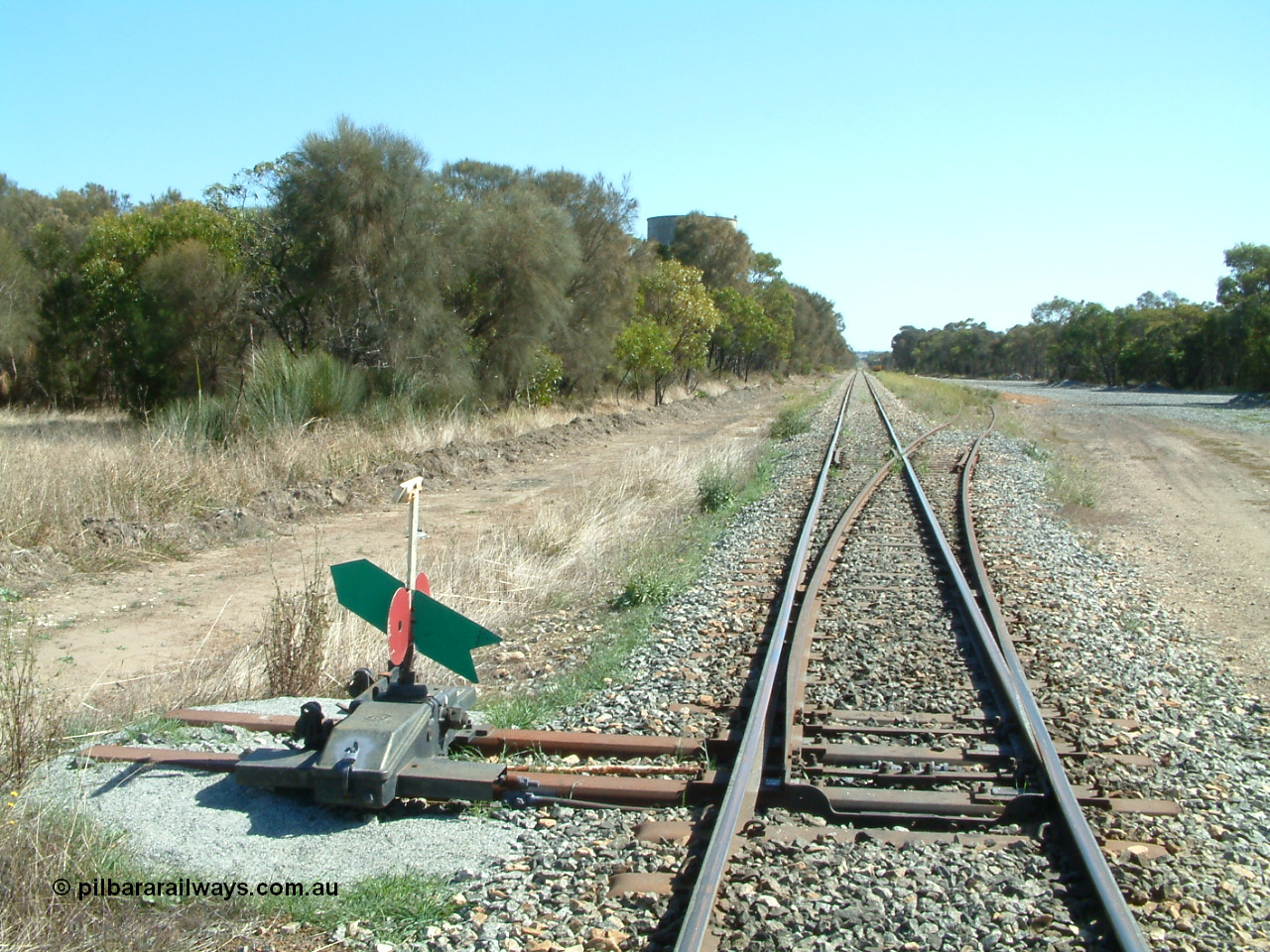 030406 105948
Coomunga, station located at the 21.6 km, opened in November 1907, used these days as a track maintenance siding. Yard overview looking north from the south end points, water tank on the left, track machines in the distance on the right. 6th April 2003.
