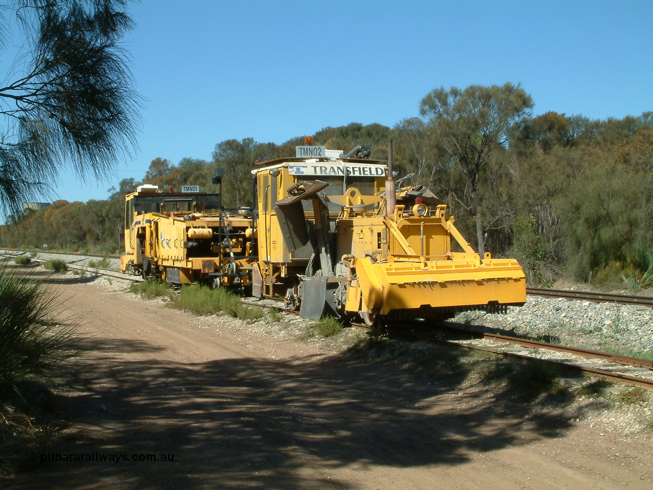 030406 110700
Coomunga, on the siding, two Transfield track machines, TMN 02, a ballast regulator and a track tamper. 6th April 2003.
Keywords: track-machine;
