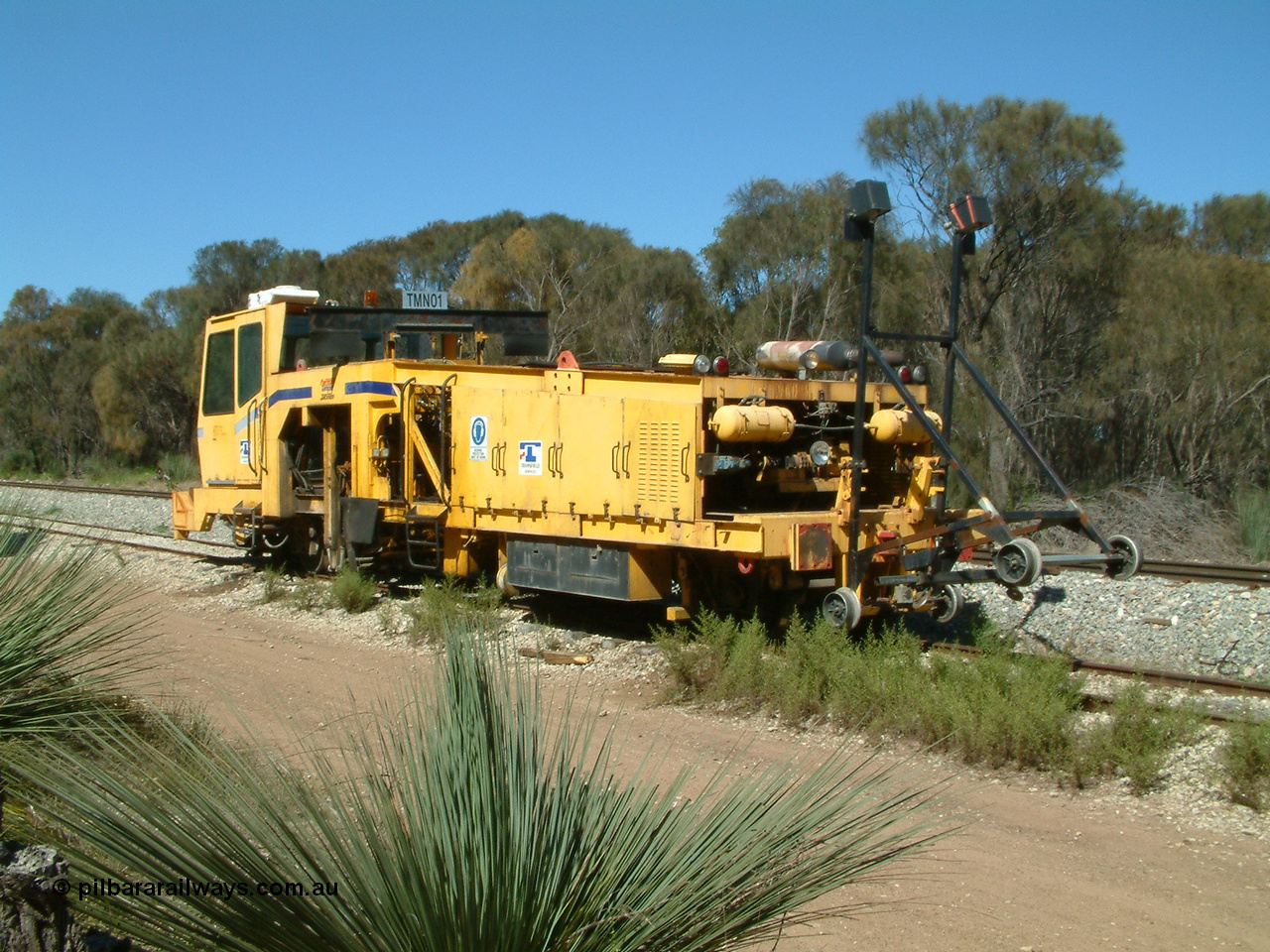 030406 110734
Coomunga, on the siding, Transfield track machine TMN 01 which is a track tamper. 6th April 2003.
Keywords: track-machine;