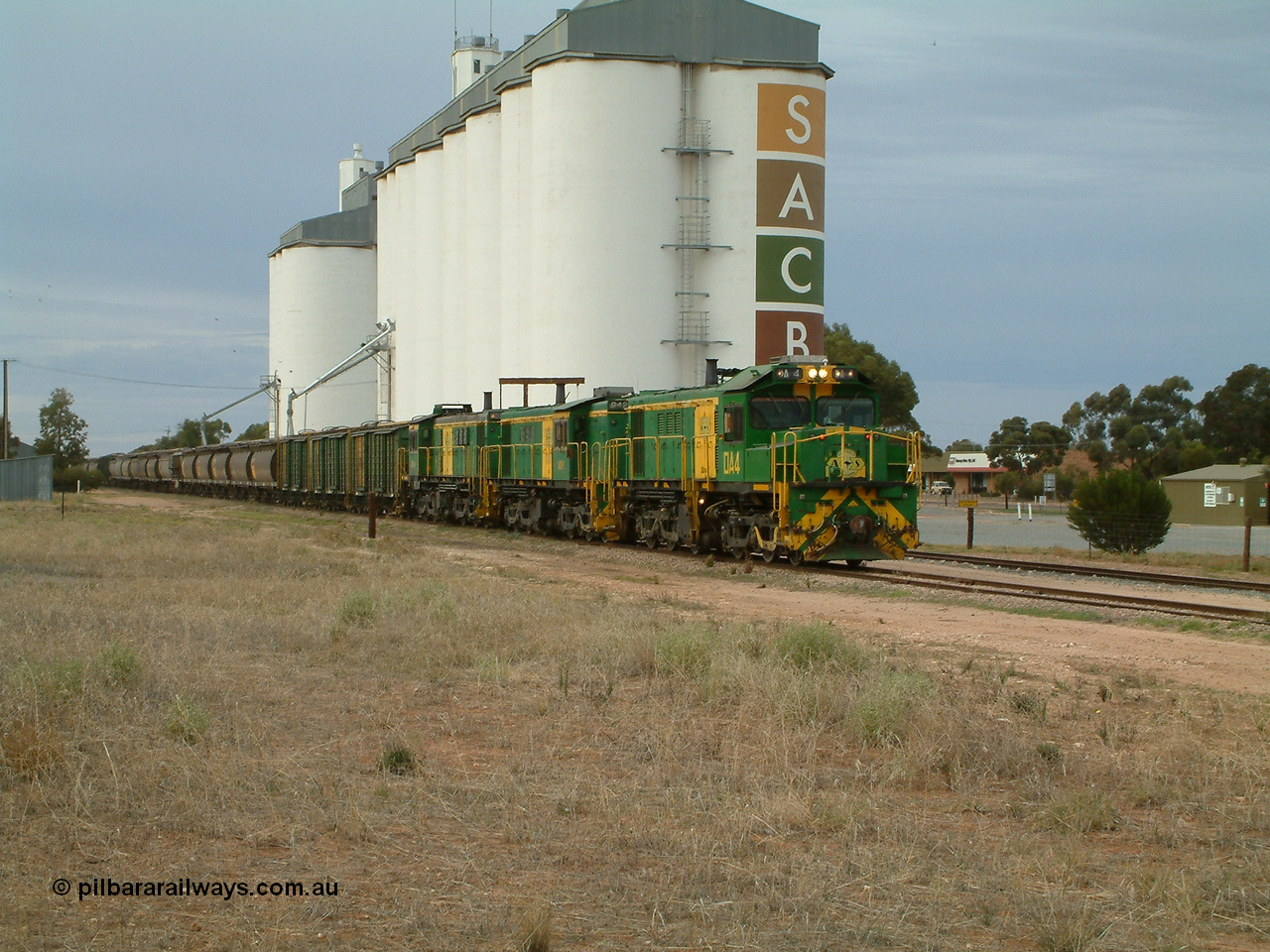 030407 082231
Wudinna, north bound empty grain train arrives behind a trio of former Australian National locomotives with rebuilt former AE Goodwin ALCo model DL531 830 class ex 839, serial 83730, rebuilt by Port Augusta Workshops to DA class, DA 4 leading two AE Goodwin ALCo model DL531 830 class units 842, serial 84140 and 851 serial 84137, 851 having been on the Eyre Peninsula since delivered in 1962, to shunt off empty waggons into the grain siding. 7th April 2003.
Keywords: DA-class;DA4;83730;Port-Augusta-WS;ALCo;DL531G/1;830-class;839;rebuild;