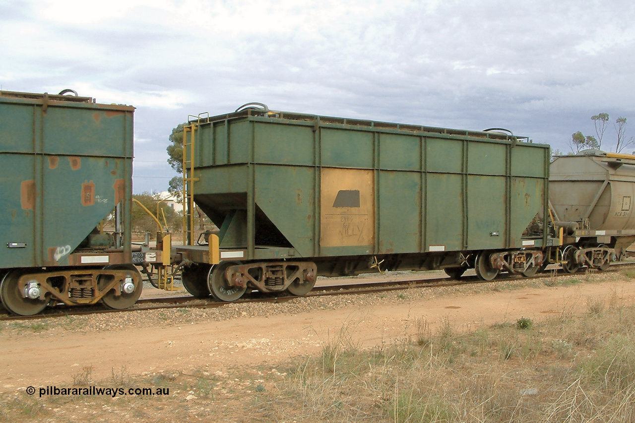 030407 082409
Wudinna, former Australian National narrow gauge ENHG type bogie grain waggon ENHG 6, originally built by Moore Road Ind, Victoria as NB type NB 1444 ballast hopper for the NAR, then to standard gauge in 1975 as BA type BA 1536, to EP July 1984, recoded to ENHT type ENHT 11 in 1985 and further rebuilt forming one half of ENHG type grain waggon in August 1986. The conversion involved splicing 2 AHTY-ENHT type waggons together at Port Lincoln Workshops. 7th April 2003.
Keywords: ENHG-type;ENHG6;Moore-Road-Ind-Victoria;NB-type;NB1444;BA-type;BA1536;ENHT-type;ENHT11;
