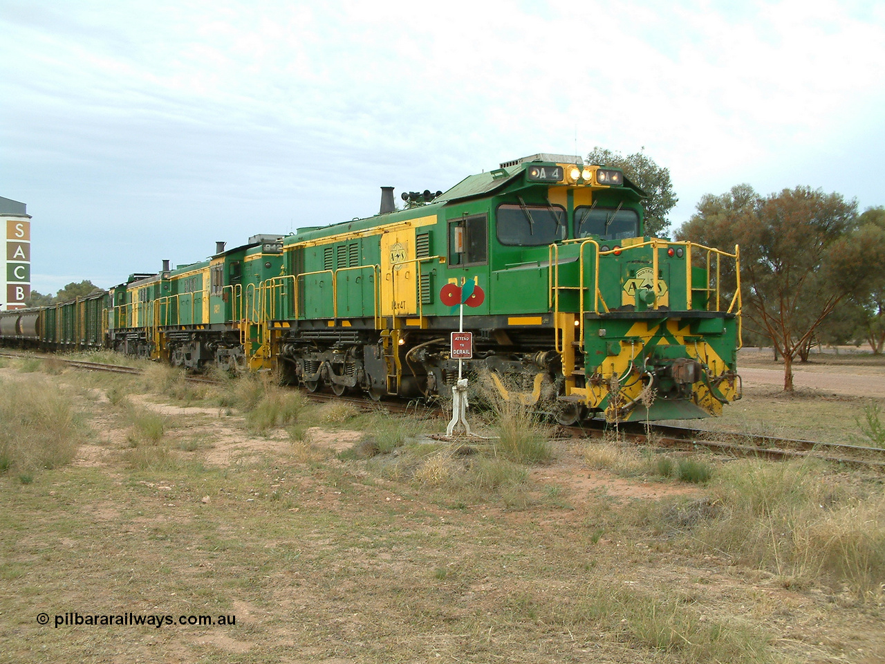030407 082757
Wudinna, empty grain train shunts back into the grain siding with a trio of former Australian National Co-Co locomotives with rebuilt former AE Goodwin ALCo model DL531 830 class ex 839, serial no. 83730, rebuilt by Port Augusta Workshops to DA class, DA 4 leading two AE Goodwin ALCo model DL531 830 class units 842, serial no. 84140 and 851 serial no. 84137, 851 having been on the Eyre Peninsula since delivered in 1962. 7th April, 2003.
Keywords: DA-class;DA4;83730;Port-Augusta-WS;ALCo;DL531G/1;830-class;839;rebuild;