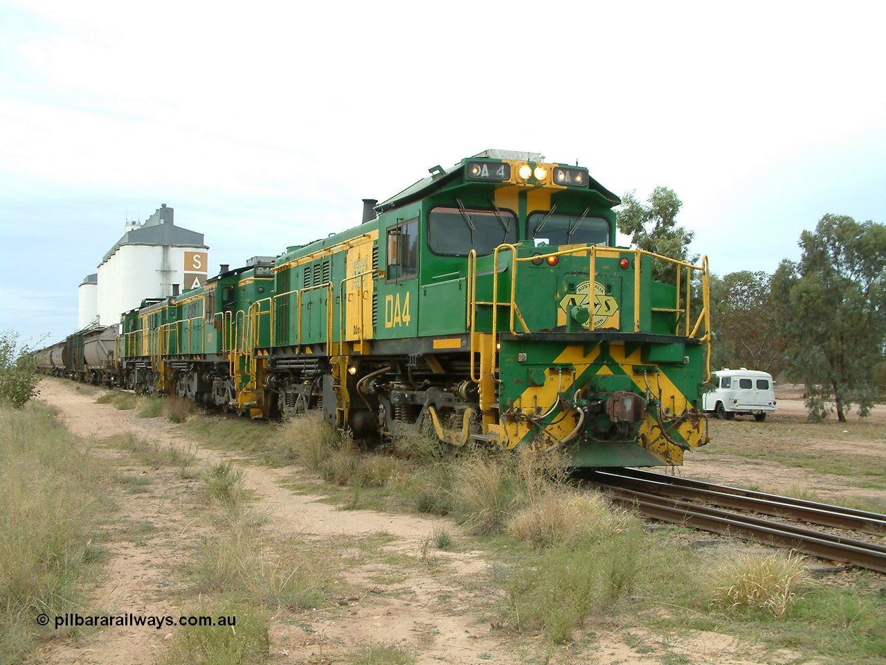030407 083422
Wudinna, empty grain train shunts back onto the empty portion on the mainline prior to departing north, with a trio of former Australian National Co-Co locomotives with rebuilt former AE Goodwin ALCo model DL531 830 class ex 839, serial no. 83730, rebuilt by Port Augusta Workshops to DA class, DA 4 leading two AE Goodwin ALCo model DL531 830 class units 842, serial no. 84140 and 851 serial no. 84137, 851 having been on the Eyre Peninsula since delivered in 1962. 7th April, 2003.
Keywords: DA-class;DA4;83730;Port-Augusta-WS;ALCo;DL531G/1;830-class;839;rebuild;