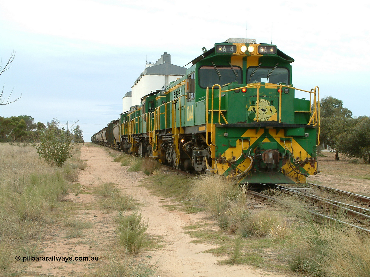 030407 083438
Wudinna, empty grain stands on the main awaiting departure north with a trio of former Australian National Co-Co locomotives with rebuilt former AE Goodwin ALCo model DL531 830 class ex 839, serial no. 83730, rebuilt by Port Augusta Workshops to DA class, leading two AE Goodwin ALCo model DL531 830 class units 842, serial no. 84140 and 851 serial no. 84137, 851 having been on the Eyre Peninsula since delivered in 1962. 7th April, 2003.
Keywords: DA-class;DA4;83730;Port-Augusta-WS;ALCo;DL531G/1;830-class;839;rebuild;