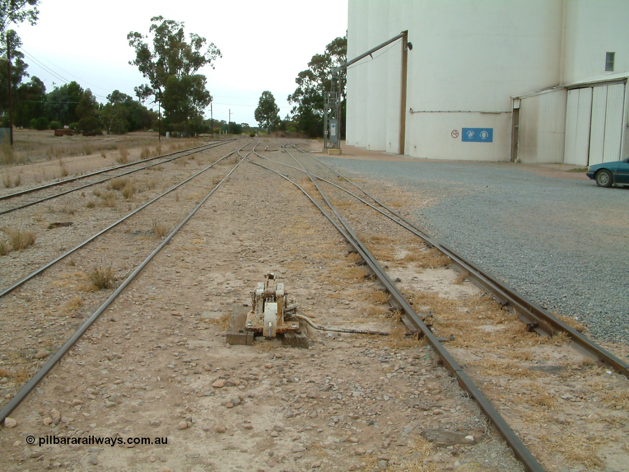 030407 094517
Minnipa, yard view looking south with cheese knob point lever for sidings, mainline is third from the right, silo out-flow spout. 7th April, 2003.

