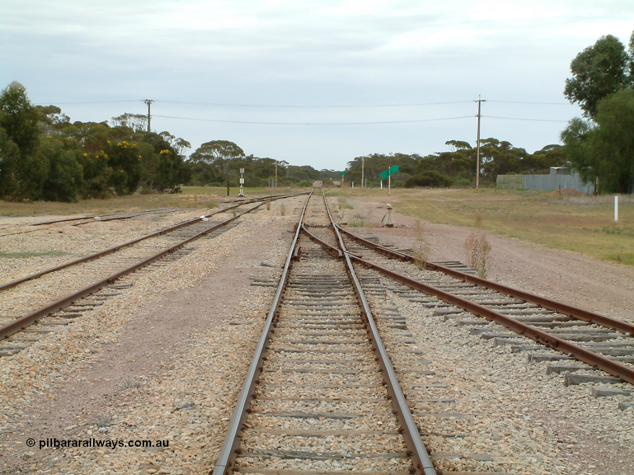 030407 094908
Minnipa, station yard overview looking north from the middle of the yard. Sidings 2 and 3 coming in from the left and Siding 1 on the right, point levers and indicators. Grade crossing in the distance. 7th April 2003.
