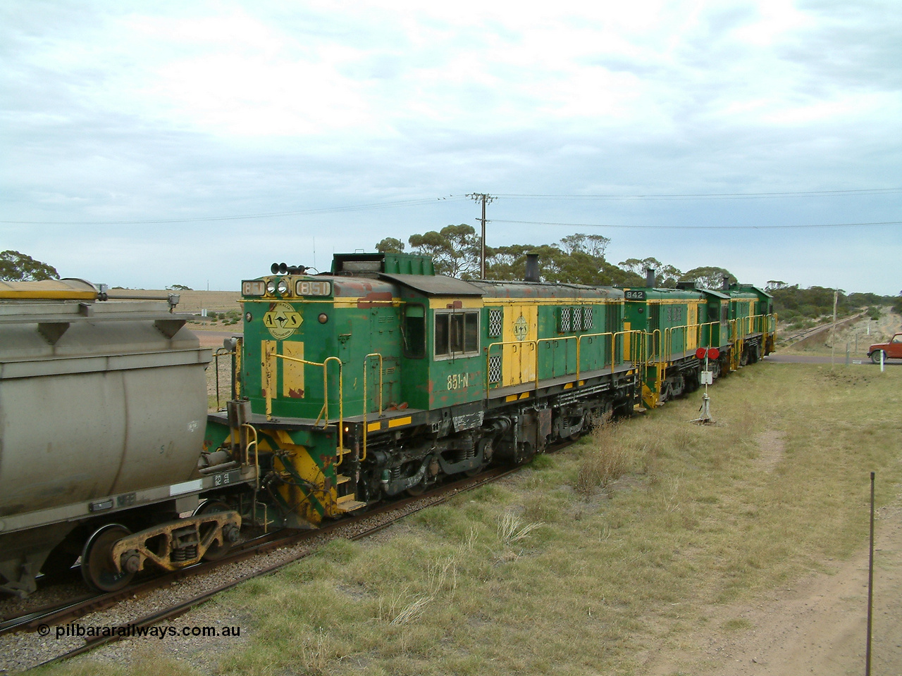 030407 100834
Minnipa, empty grain train shunts back into the grain siding with a trio of former Australian National Co-Co locomotives with rebuilt former AE Goodwin ALCo model DL531 830 class ex 839, serial no. 83730, rebuilt by Port Augusta Workshops to DA class, leading two AE Goodwin ALCo model DL531 830 class units 842, serial no. 84140 and 851 serial no. 84137, 851 having been on the Eyre Peninsula since delivered in 1962. 7th April, 2003.
Keywords: 830-class;851;AE-Goodwin;ALCo;DL531;84137;