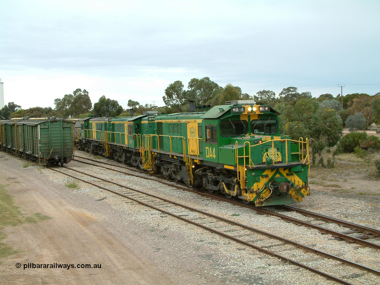 030407 100858
Minnipa, empty grain train shunts back into the grain siding with a trio of former Australian National Co-Co locomotives with rebuilt former AE Goodwin ALCo model DL531 830 class ex 839, serial no. 83730, rebuilt by Port Augusta Workshops to DA class, leading two AE Goodwin ALCo model DL531 830 class units 842, serial no. 84140 and 851 serial no. 84137, 851 having been on the Eyre Peninsula since delivered in 1962. 7th April, 2003.
Keywords: DA-class;DA4;83730;Port-Augusta-WS;ALCo;DL531G/1;830-class;839;rebuild;