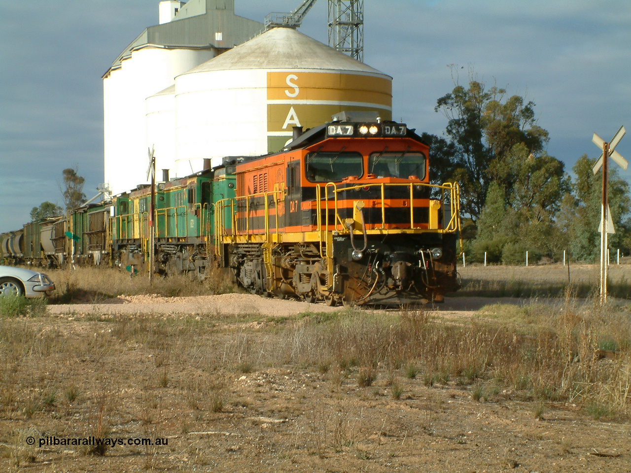 030409 080852
Warramboo, empty grain departs following a crew change. Rebuild unit DA 7 in Australian Southern orange and black livery leads a pair of AE Goodwin built ALCo model DL531 830 class units 872 and 871, the SACBH concrete silo and Ascom silo complexes behind it.
Keywords: DA-class;DA7;83713;Port-Augusta-WS;ALCo;DL531G/1;48-class;4813;rebuild;