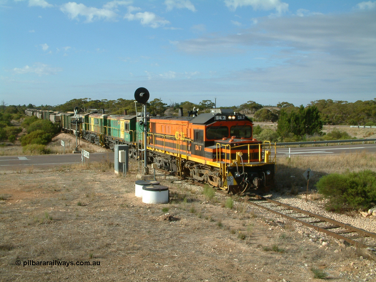 030409 084528
Kyancutta, empty grain train arrives across the Eyre Highway grade crossing behind rebuild DA class unit DA 7 in Australian Southern orange and black livery leading a pair of AE Goodwin built ALCo model DL531 830 class units 872 and 871 with a string of grain waggons.
Keywords: DA-class;DA7;83713;Port-Augusta-WS;ALCo;DL531G/1;48-class;4813;rebuild;