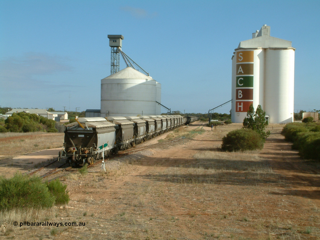 030409 084719
Kyancutta, XNW type bogie grain hopper waggon XNW 12 on the rear of a string of twelve such waggons, Comeng Qld built XNG type bogie waggon for Norseman Goldmines NL, then WAGR owned and coded XNA then in 1994 converted to XNW grain waggons. They arrived on the Eyre Peninsula system from 2001.
Keywords: XNW-type;XNW12;Comeng-Qld;XNG-type;XNA-type;