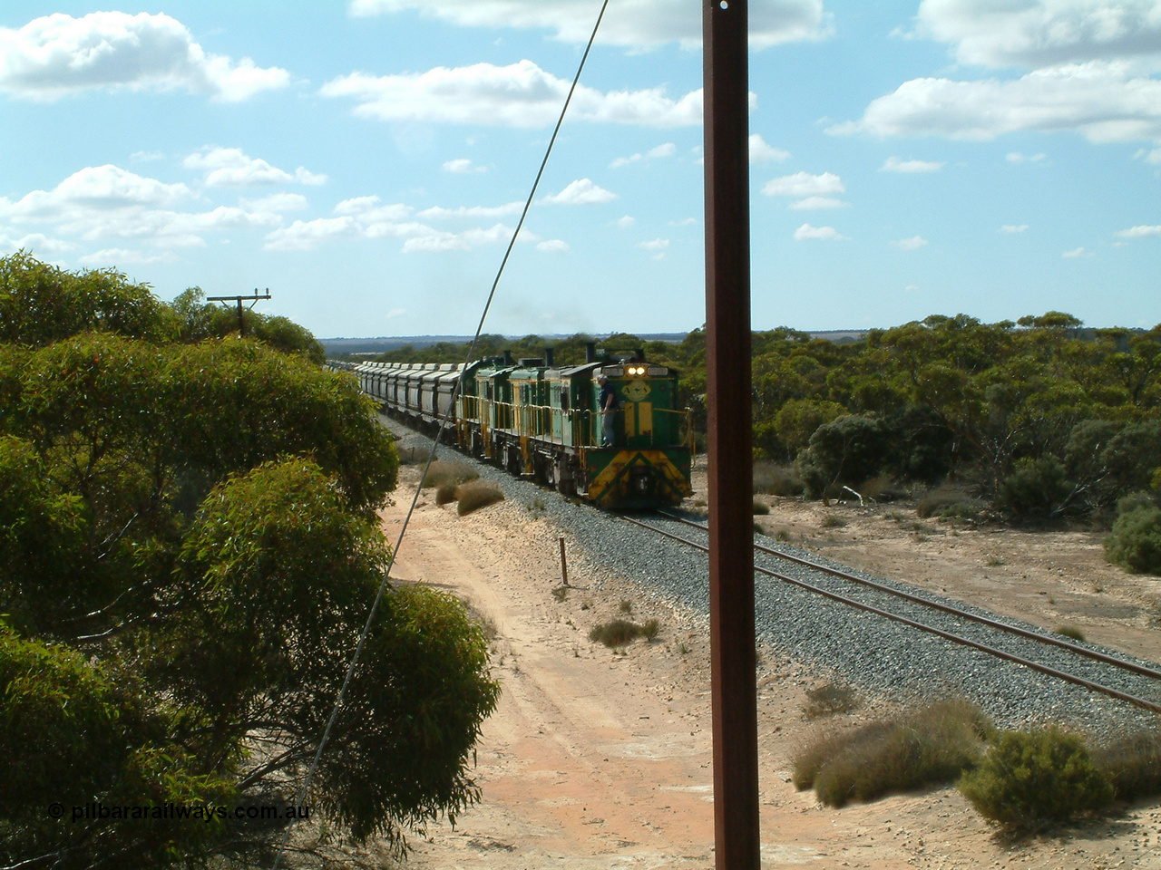 030409 110601
Caralue, loaded grain train working south of the former station site while one driver has a smoke, 830 class unit 851 AE Goodwin ALCo model DL531 serial 84137, 851 has spent its entire operating career on the Eyre Peninsula, it leads fellow 830 class 842 serial 84140 and a rebuilt unit DA 4, rebuilt from 830 class unit 839 by Port Augusta Workshops, retains original serial 83730 and model DL531.
Keywords: 830-class;851;AE-Goodwin;ALCo;DL531;84137;