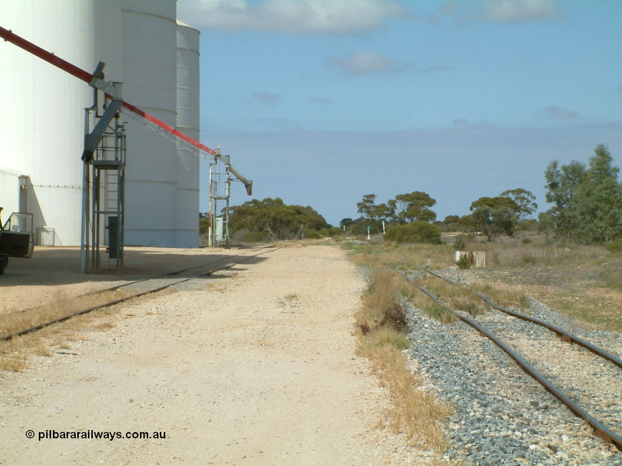 030409 112310
Darke Peake, yard view looking south with grain loading spouts and silos on the goods and grain loop at left, mainline on the right.

