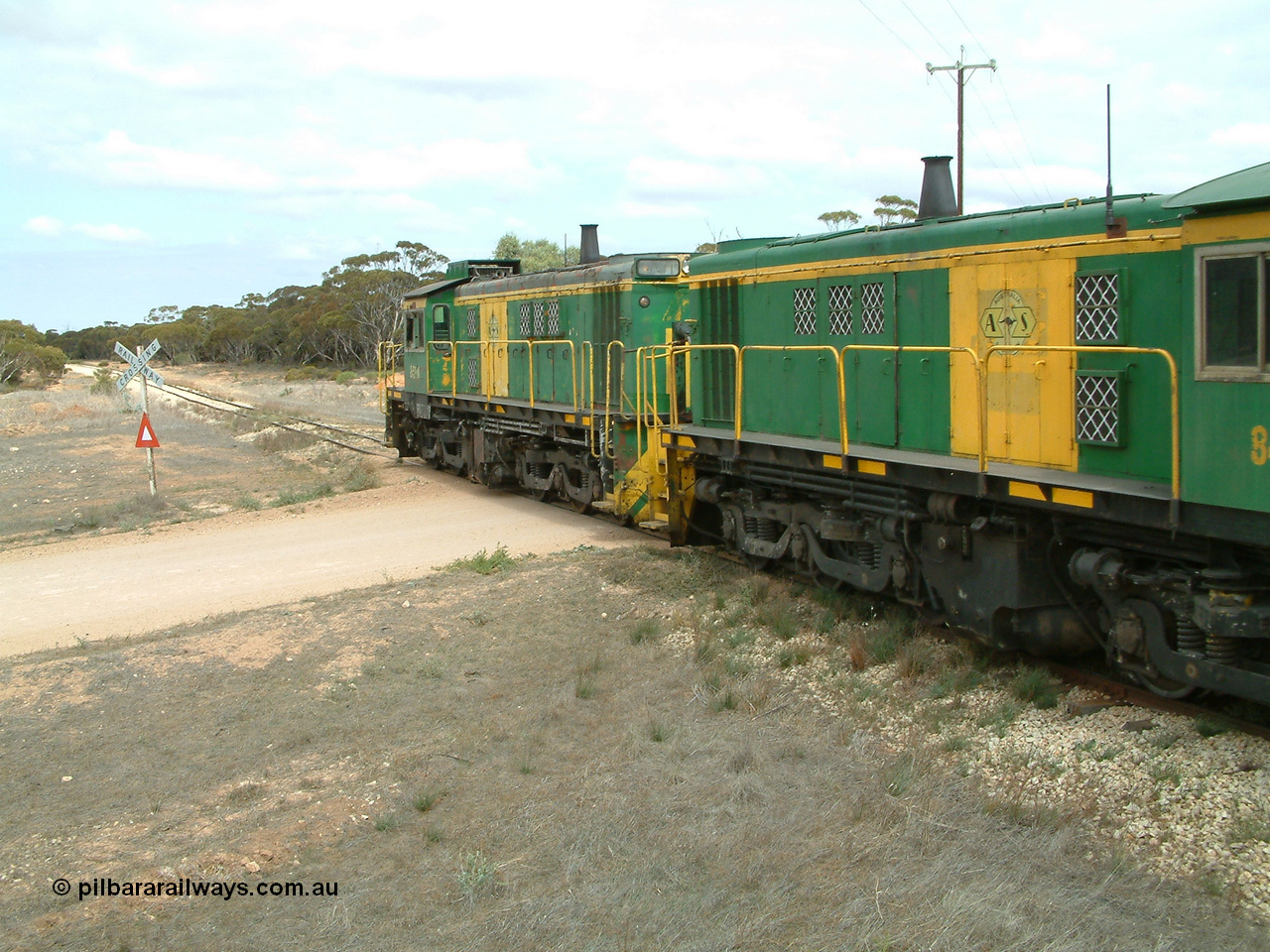 030409 115610
Darke Peake, at the 195 km Dog Fence Road grade crossing loaded grain train with 830 class unit 851 AE Goodwin ALCo model DL531 serial 84137, 851 has spent its entire operating career on the Eyre Peninsula, leads fellow 830 class 842 serial 84140 and a rebuilt unit DA 4, rebuilt from 830 class unit 839 by Port Augusta Workshops, retains original serial 83730 and model DL531 with the first twelve waggons behind the locos XNW type.
Keywords: 830-class;851;AE-Goodwin;ALCo;DL531;84137;