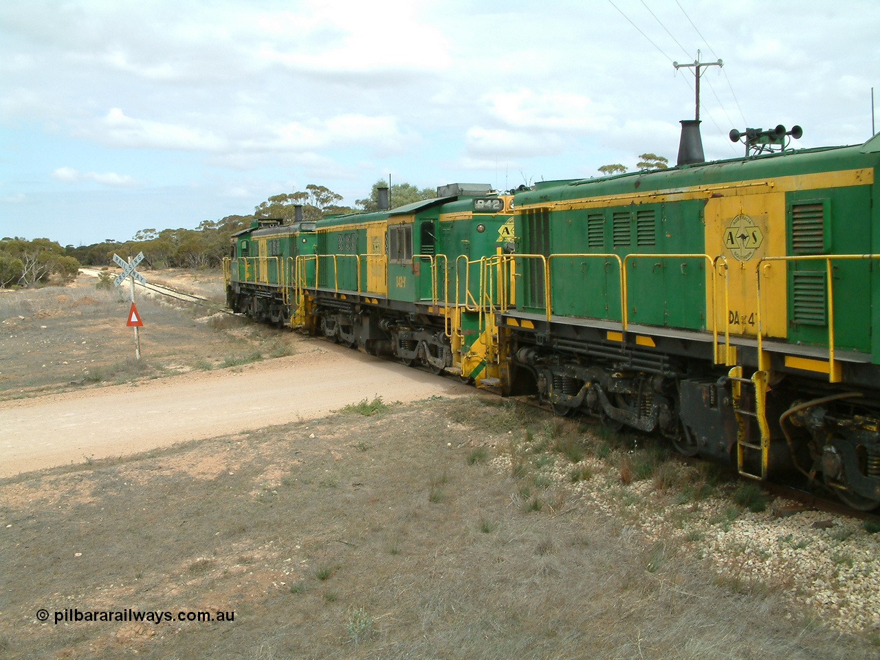 030409 115614
Darke Peake, at the 195 km Dog Fence Road grade crossing loaded grain train with 830 class unit 851 AE Goodwin ALCo model DL531 serial 84137, 851 has spent its entire operating career on the Eyre Peninsula, leads fellow 830 class 842 serial 84140 and a rebuilt unit DA 4, rebuilt from 830 class unit 839 by Port Augusta Workshops, retains original serial 83730 and model DL531 with the first twelve waggons behind the locos XNW type.
Keywords: 830-class;842;AE-Goodwin;ALCo;DL531;84140;