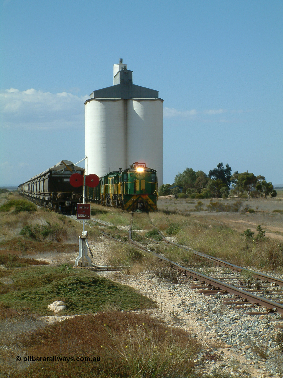 030409 141326
Wharminda, the engines 830 class unit 851 AE Goodwin ALCo model DL531 serial 84137, fellow 830 class 842 serial 84140 and a rebuilt unit DA 4 shunt back out of the siding for the mainline with the loaded waggons.
Keywords: 830-class;851;AE-Goodwin;ALCo;DL531;84137;