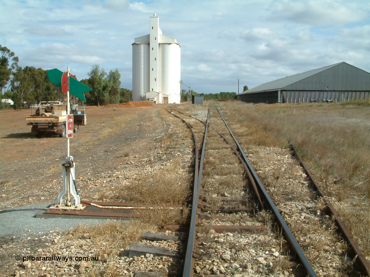 030409 145852
Ungarra, located at the 108.1 km and opened in March 1913 as the temporary terminus till July 1913. Yard overview looking south from the goods and grain loop points, loading ramp can be made out in front of car, silo complex, station hut then the horizontal grain bunker on the right.
