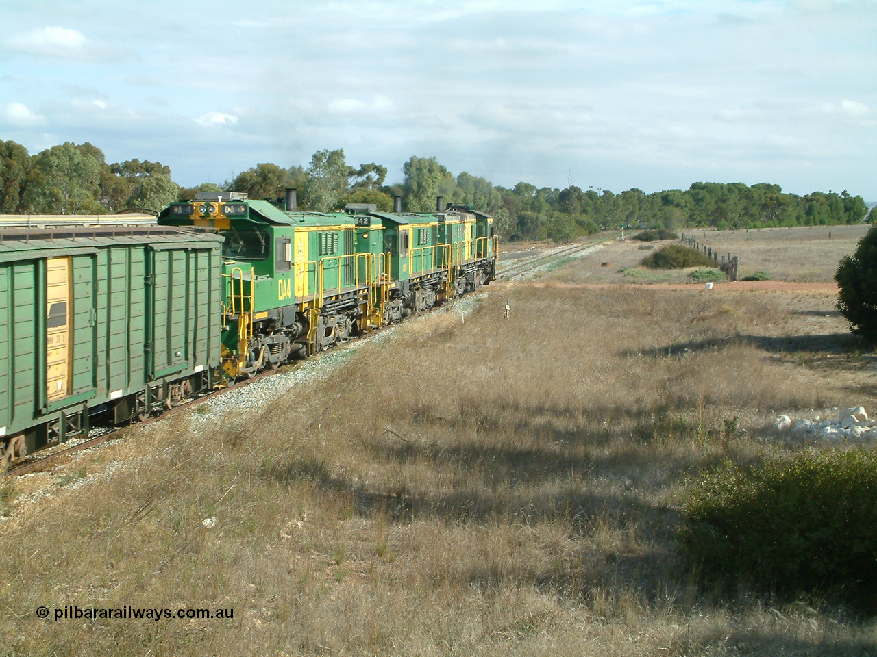 030409 152433
Ungarra, the peace is shattered as a loaded grain train storms upgrade through the station behind 830 class unit 851 AE Goodwin ALCo model DL531 serial 84137, fellow 830 class 842 serial 84140 and a rebuilt DA class unit DA 4 trailing view as the continue south.
Keywords: DA-class;DA4;83730;Port-Augusta-WS;ALCo;DL531G/1;830-class;839;rebuild;