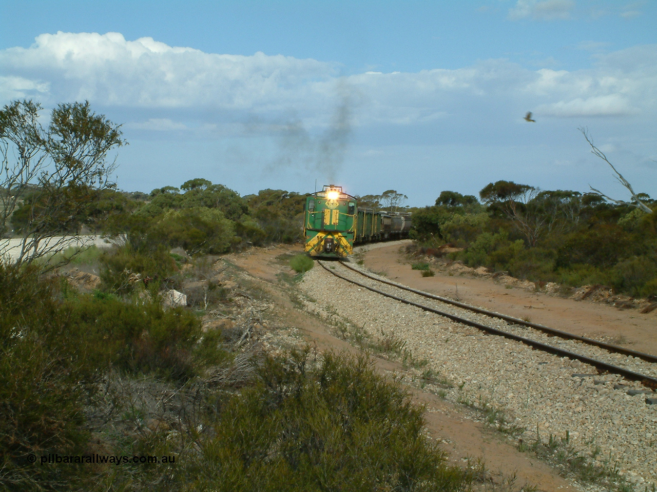 030409 153926
Moody Tank, a loaded grain train storms around the curve behind 830 class unit 851 AE Goodwin ALCo model DL531 serial 84137, fellow 830 class 842 serial 84140 and a rebuilt DA class unit DA 4.
Keywords: 830-class;851;AE-Goodwin;ALCo;DL531;84137;