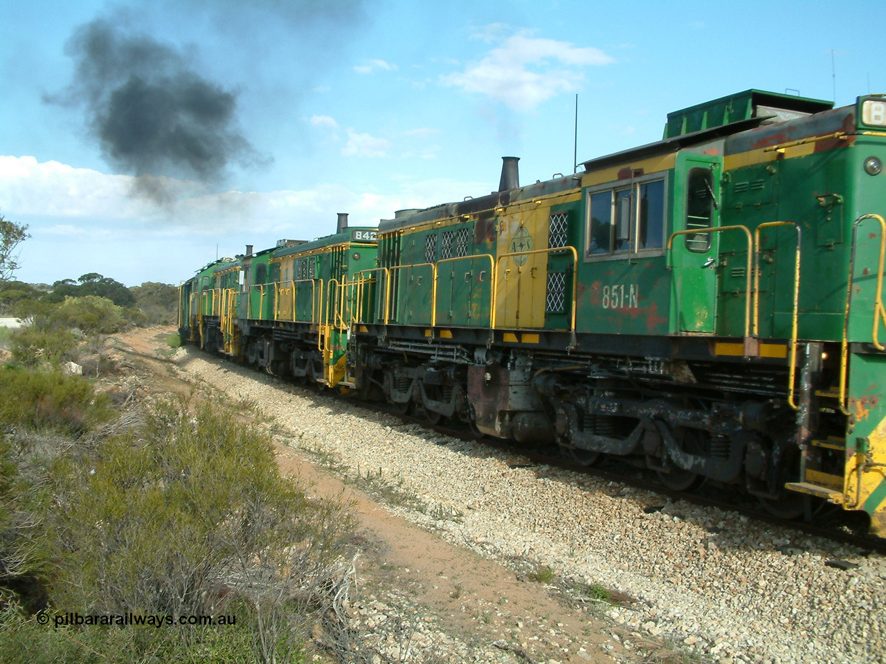 030409 153940
Moody Tank, a loaded grain train storms around the curve behind 830 class unit 851 AE Goodwin ALCo model DL531 serial 84137, fellow 830 class 842 serial 84140 and a rebuilt DA class unit DA 4.
Keywords: 830-class;851;AE-Goodwin;ALCo;DL531;84137;