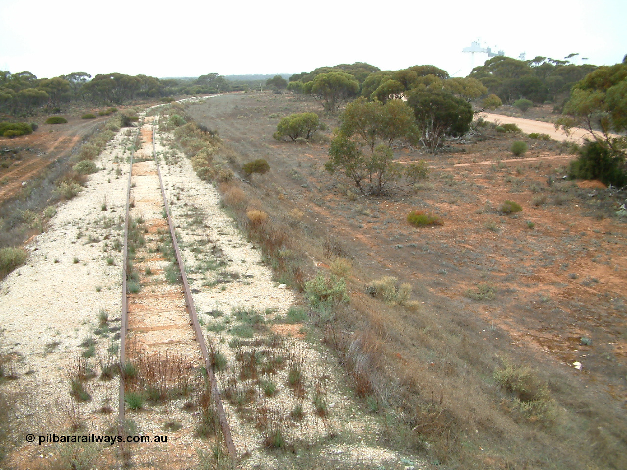 030411 085336
Buckleboo, the end of the line looking south around the curve to the station, a once planned extension onto the Pinkawillinie lands never proceeded. [url=https://goo.gl/maps/HjW1xkya1xC2]Geodata here[/url]. The silos are a bit washed out due to the drizzly conditions.
