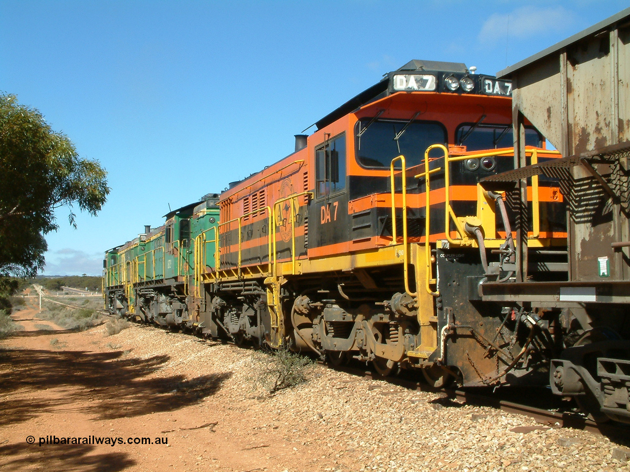 030411 102054
Kimba Grain Bunker, looking towards Kimba with Aerodrome Rd in the distance, ALCo DL531G/1 model rebuilt from an AE Goodwin made ALCo DL531 48 class 4813 serial 83713, issued to Eyre Peninsula from new in March 1966, and two 830 class units, 871 and 872 prepare to depart with a loaded. 11th April 2003. [url=https://goo.gl/maps/Et8bgaqpMnn]Geodata here[/url].
Keywords: DA-class;DA7;83713;Port-Augusta-WS;ALCo;DL531G/1;48-class;4813;rebuild;