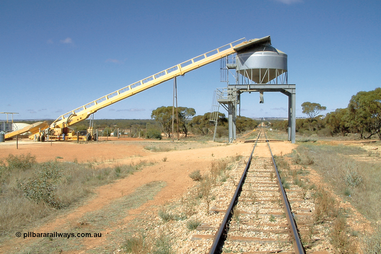 030411 105103
Kimba Grain Bunker site, overhead mainline loading bin, looking south towards Kimba, augers from the storage area on the left.
