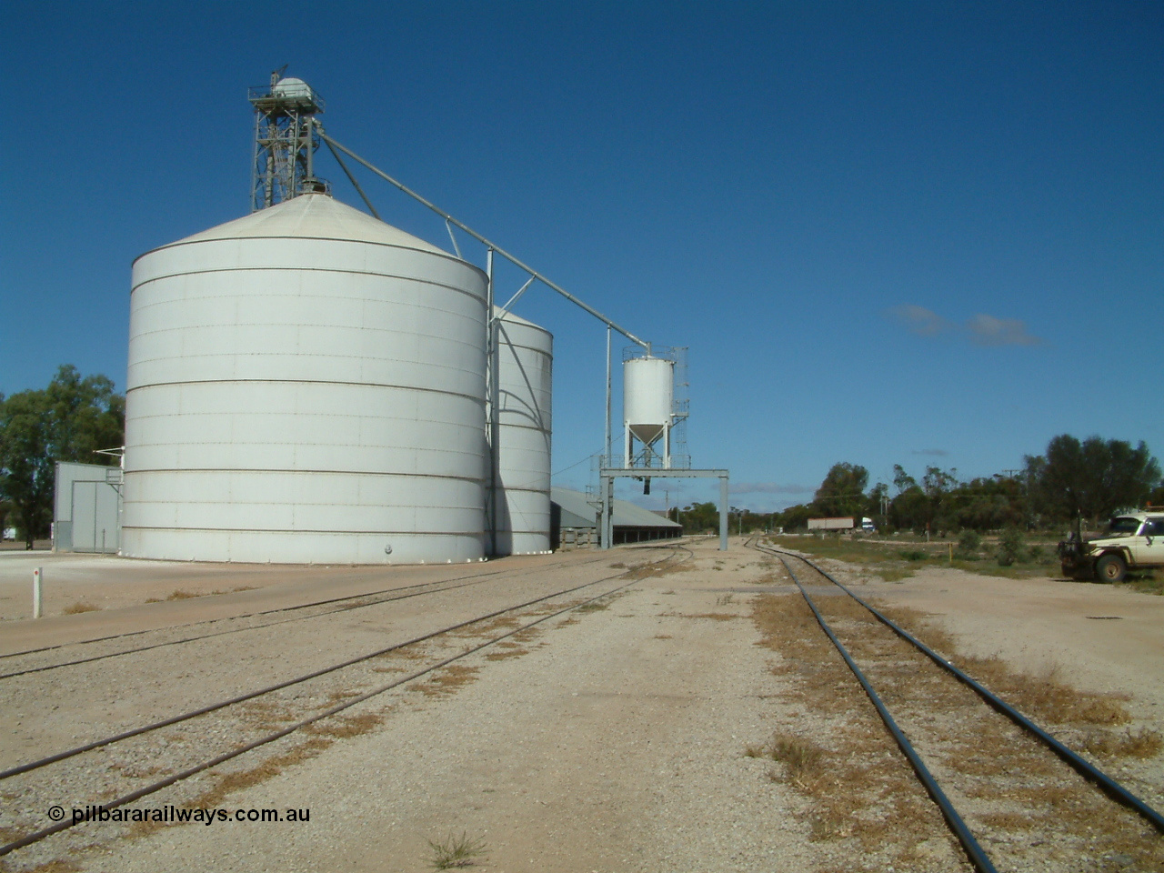 030411 110609
Kimba, view looking south of the Ascom Jumbo style silo complex, truck discharge on the left, outloading spout and silo over rail, horizontal bunker behind.
