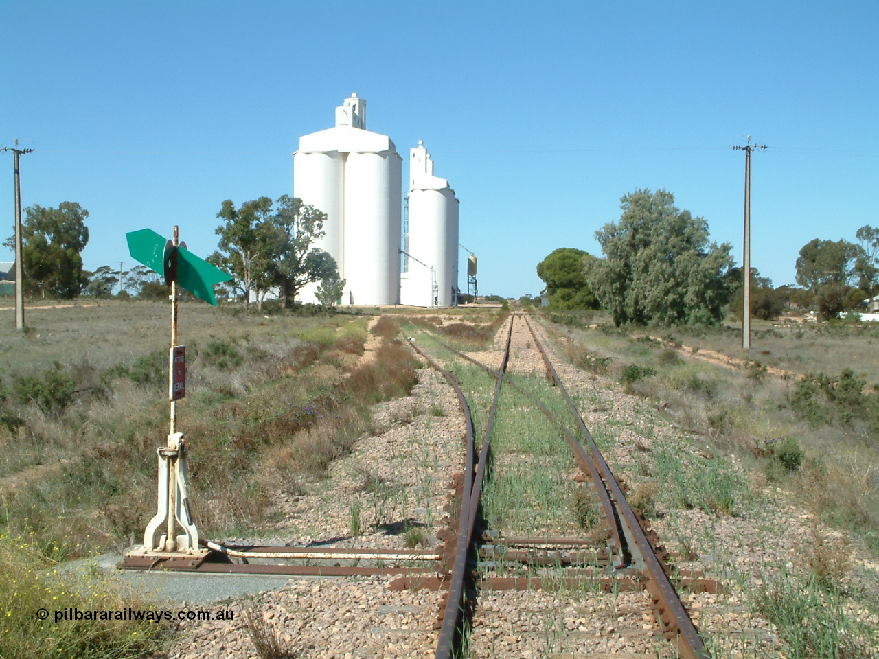 030411 141109
Nunjikompita, aboriginal word for 'burnt hair', located 357.6 km, terminus of line from 14th August 1914 until Thevenard extension opened on the 8th of February 1915, yard overview looking east from the western end of the yard. Concrete silo block 3 is closet to camera.
