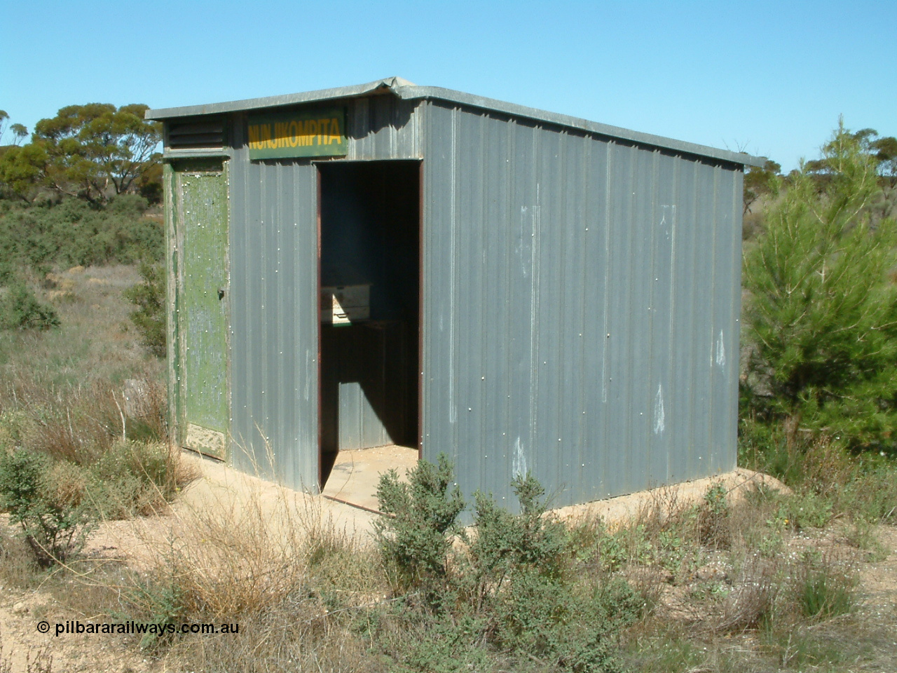 030411 141342
Nunjikompita, aboriginal word for 'burnt hair', located , terminus of line from 14th August 1914 until Thevenard extension opened on the 8th of February 1915, 'station' shelter shed, consignment register desk still in situ.
