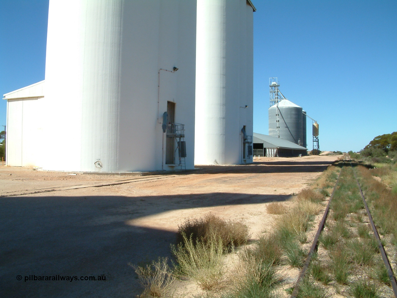 030411 141503
Nunjikompita, yard view looking east, concrete silo block 2, then 1, then a horizontal bunker then an Ascom style silo with loadout spout and silo.
