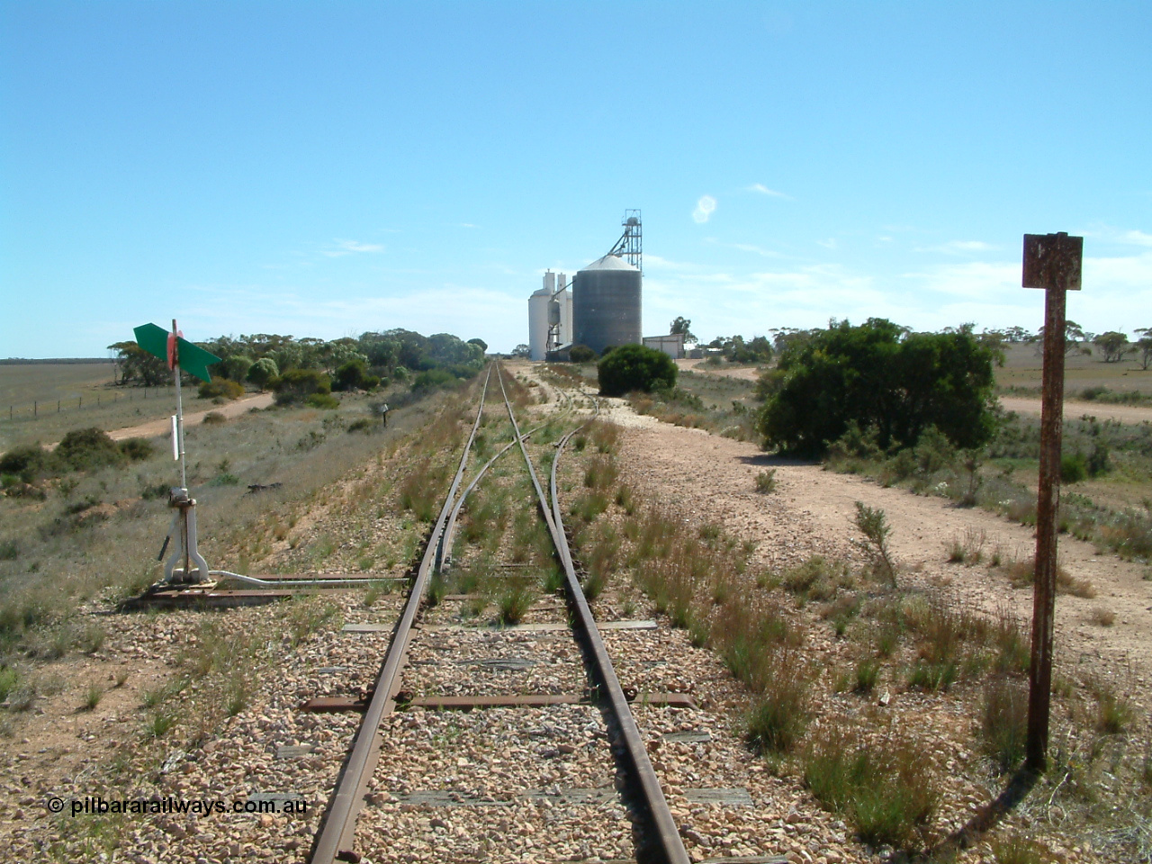030411 141732
Nunjikompita, yard view looking west, Ascom style silo with loadout spout and silo, then a horizontal bunker and concrete silos. The truck unloading point is on the right of the silos.
