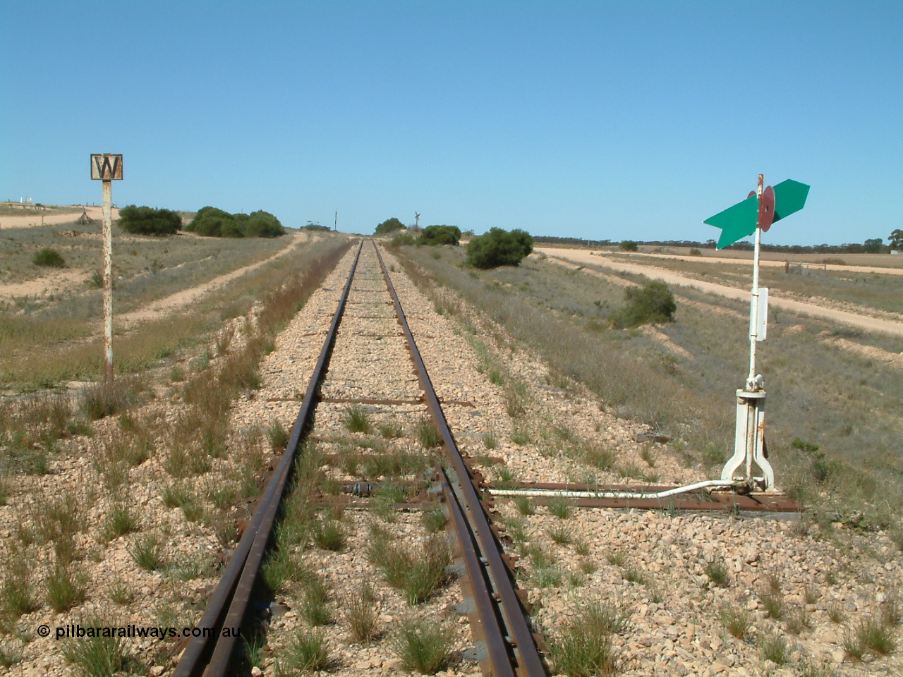 030411 141801
Nunjikompita, looking east from the east end of the yard, W whistle or horn post for grade crossing of Nunyah Road in the distance.
