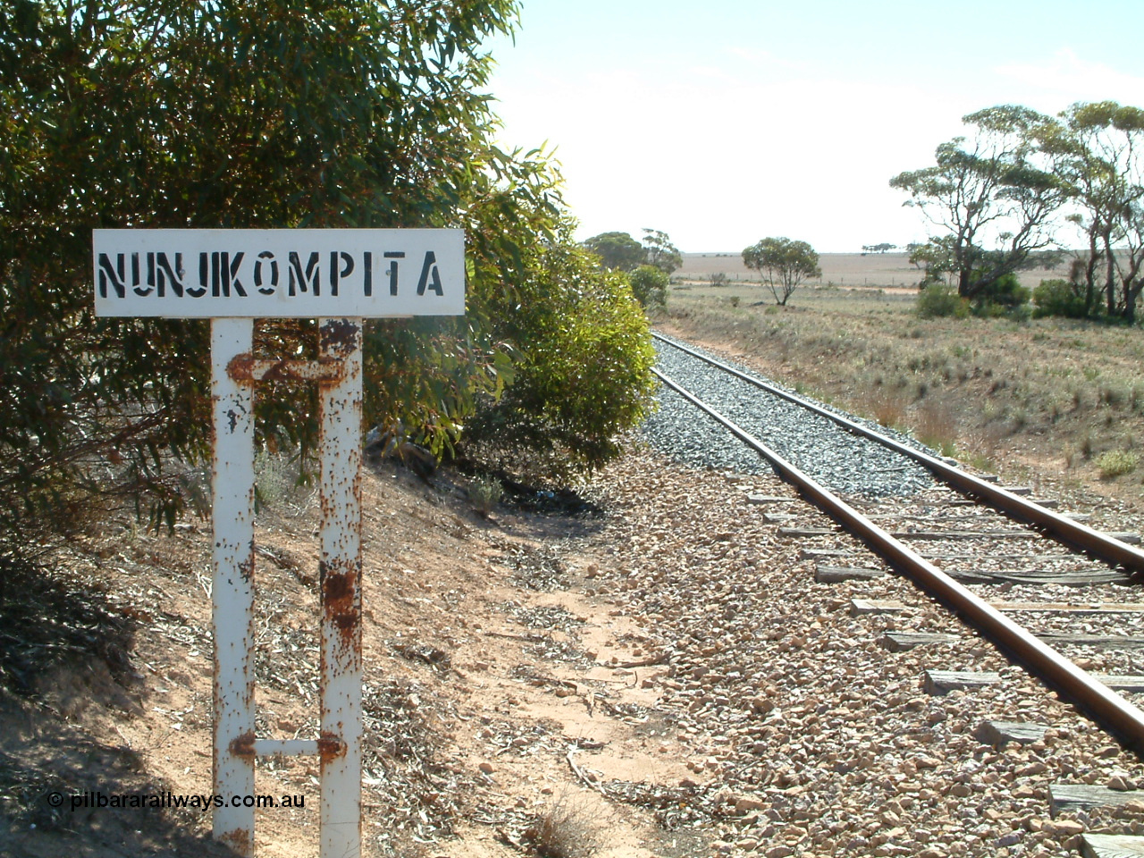 030411 142235
Nunjikompita, yard or station location sign, located about a kilometre out from the actual location. Fresh ballast is on the line.
