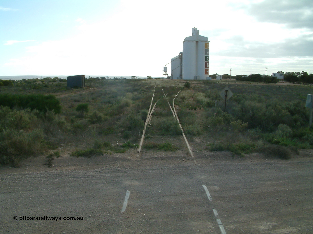 030414 154644
Penong , view looking west at yard across grade crossing, shelter on the left. Last train was in March 1997.
