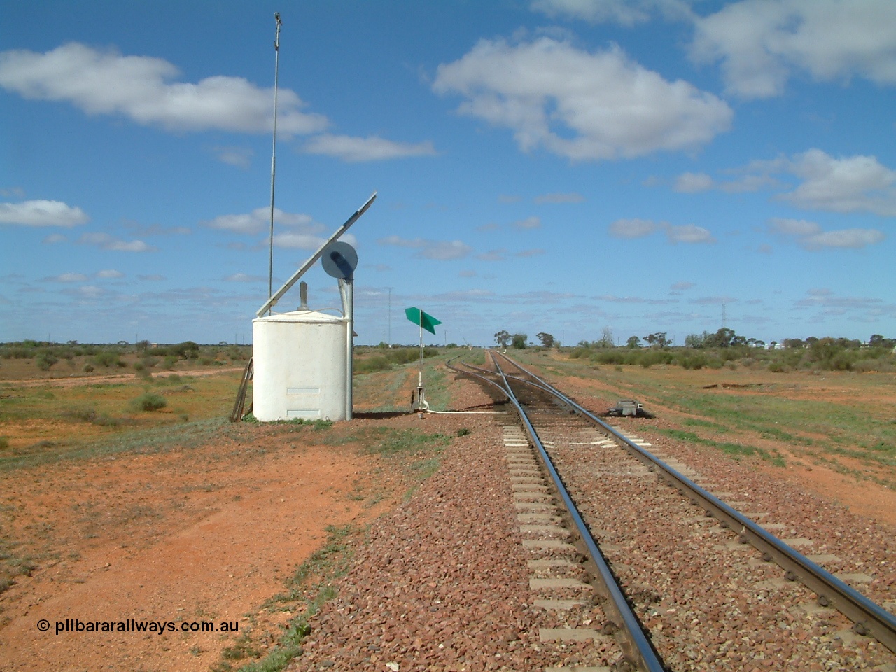 030415 140558
Kingoonya, located at the 426.5 km on the Trans Australian Railway, looking east from the western end of the 1800 metre long crossing location, interlocking hut with searchlight signal, solar array, point indicator and dual control point machine. The timber sleepers for the point work clearly evident, town off to the right. [url=https://goo.gl/maps/rY8C9mU9iF4tBmjF7]GeoData location[/url].
