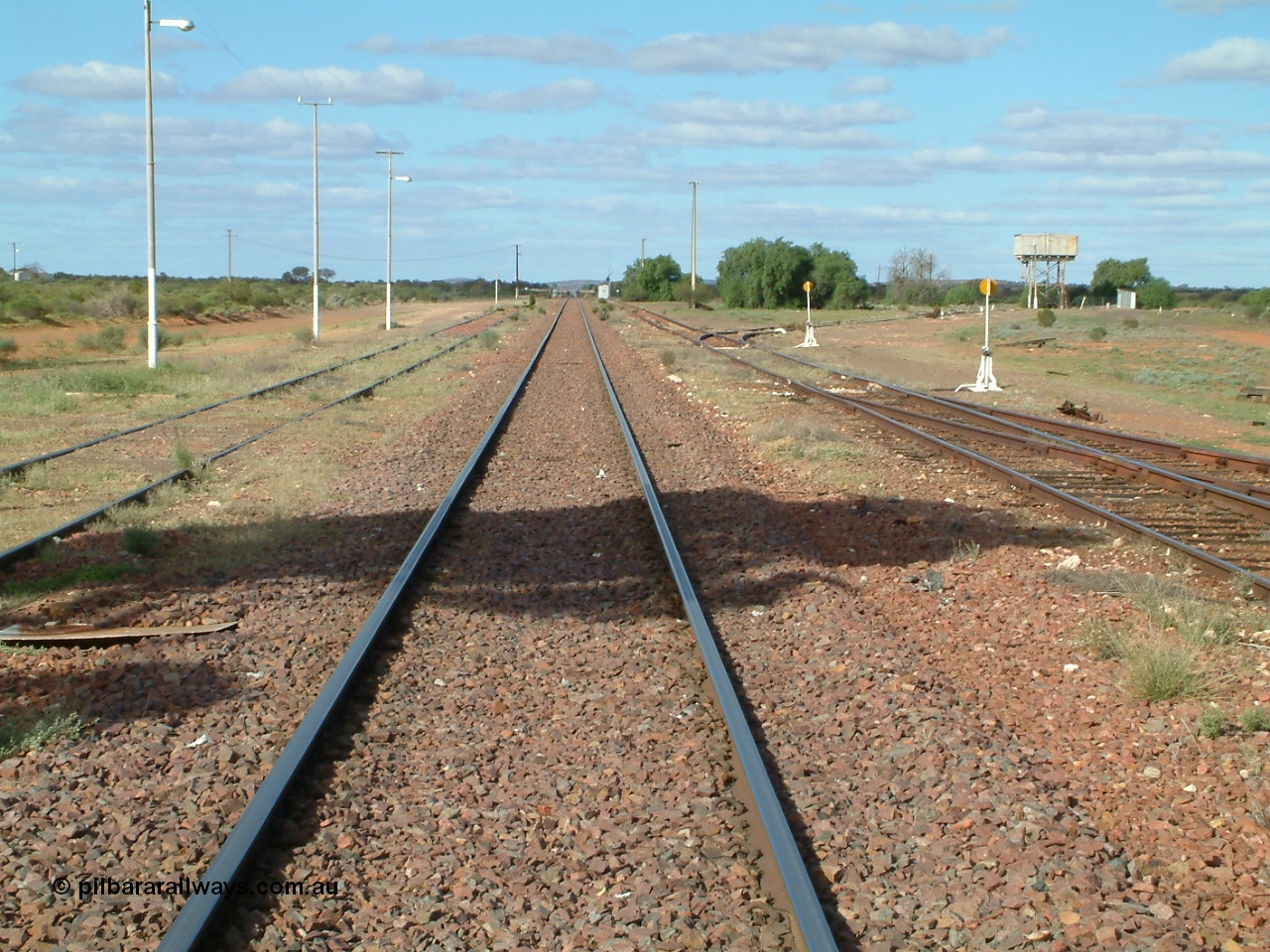 030415 154424
Tarcoola, at the 504.5 km, looking east along the Trans Australian Railway in the middle of the yard, the Central Australian Railway is on the left, loop on the right, east leg of triangle is just in view with the sidings running east behind the large tree and water tank. Tarcoola is the junction for the TAR and CAR railways situated 504 km from the 0 km datum at Coonamia. [url=https://goo.gl/maps/cWayk3LD2QQjX6Z88]GeoData location[/url]. 15th April 2003.
