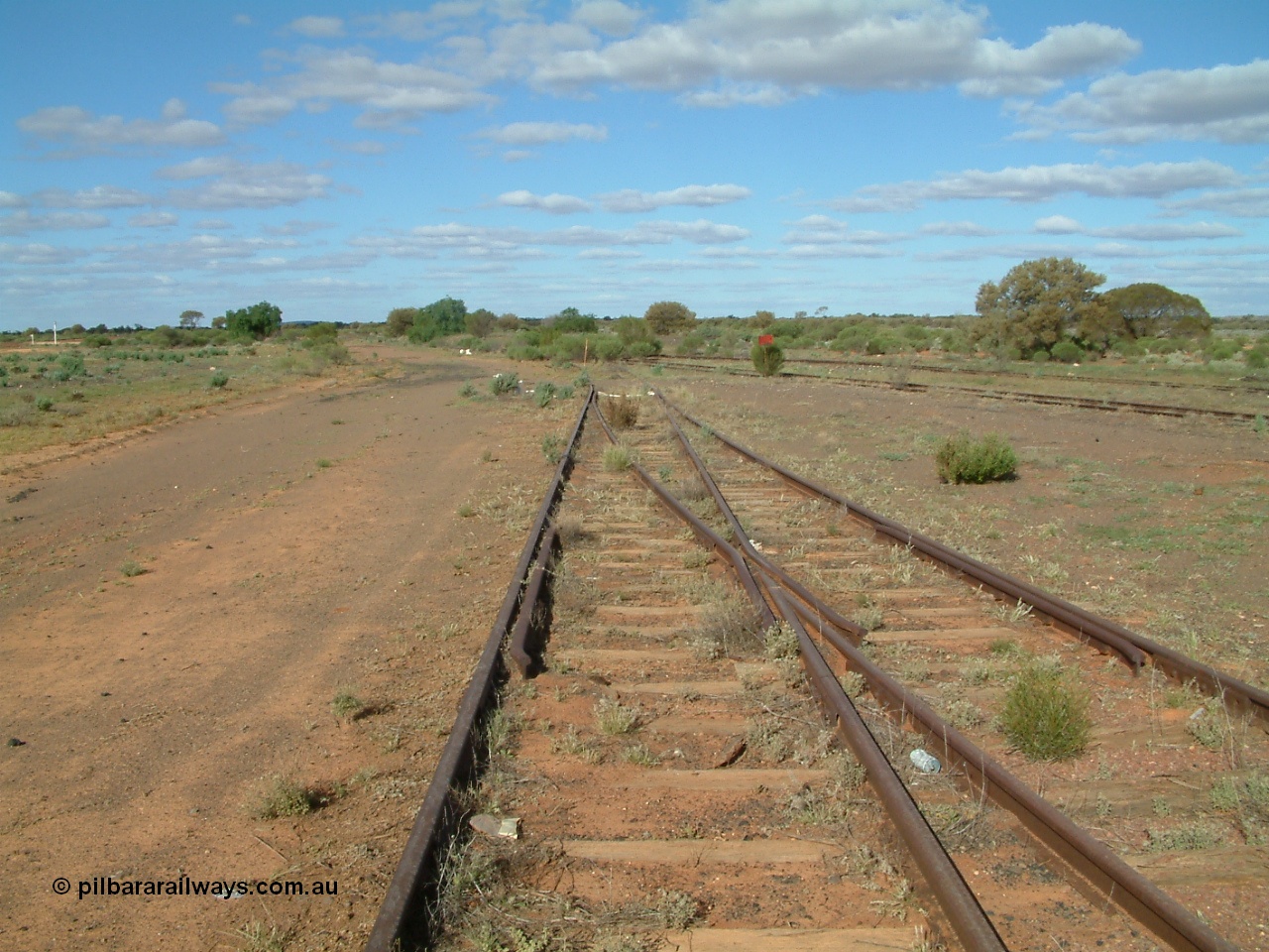 030415 155056
Tarcoola, at the 504.5 km, looking east, end of the Camp Train and No. 1 Loco roads at the points, while No. 2 Loco and No. 1 Water Road curve in from the right, mainline to the left. [url=https://goo.gl/maps/9wxzgiU7GAe9hPjz5]GeoData location[/url]. 15th April 2003.
