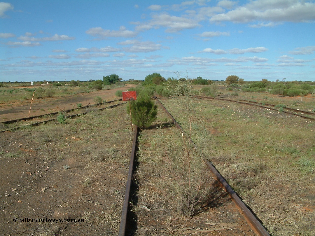 030415 155126
Tarcoola, at the 504.5 km, looking east, end of the No. 2 Loco Road, No. 1 Water Road curving in from the right, spur from Camp Train and No. 1 Loco Roads as left and mainline to the far left. [url=https://goo.gl/maps/PdmQ6oubAatDdHrL7]GeoData location[/url]. 15th April 2003.
