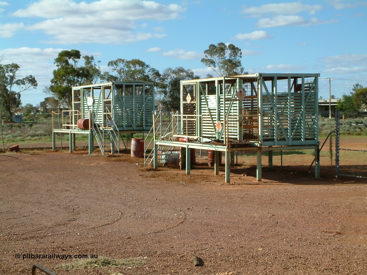 030415 160010
Tarcoola, at the 504.5 km, works compound see old livestock waggons converted to storage shed for gas bottles and the like. [url=https://goo.gl/maps/6oGe5dhUe3chHeB57]GeoData location[/url]. 15th April 2003.
