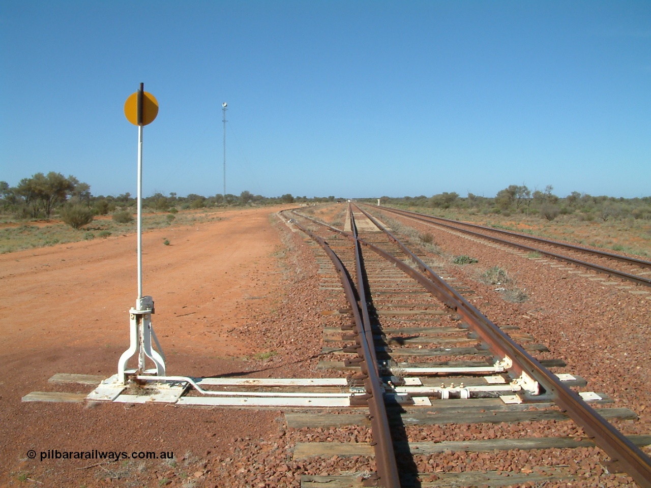 030416 095258
Wirrida Siding, looking south towards Tarcoola with the goods siding and points rejoining the loop, notice the points are on timber sleepers while the loop and mainlines are on concrete, train control 'pillbox' in the distance. Located at the 641 km from the 0 datum at Coonamia and 137 km north of Tarcoola between Carnes and Manguri on the Tarcoola - Alice Springs line. [url=https://goo.gl/maps/kr4tGiBQqpQpopy56]GeoData location[/url]. 16th April 2003.
