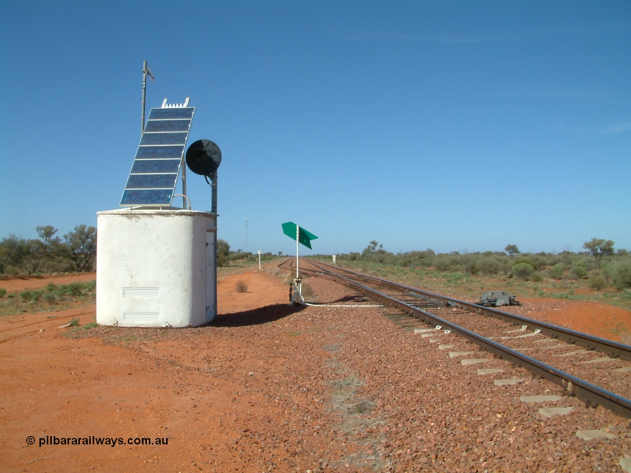 030416 095502
Wirrida Siding, looking south towards Tarcoola from the north end of the loop, concrete interlocking hut with searchlight repeater signal, point indicator, communications tower in the distance on the left and train control 'pillbox' on the right. Located at the 641 km from the 0 datum at Coonamia and 137 km north of Tarcoola between Carnes and Manguri on the Tarcoola - Alice Springs line. [url=https://goo.gl/maps/corZKNsBFkCGAnkR8]GeoData location[/url]. 16th April 2003.
