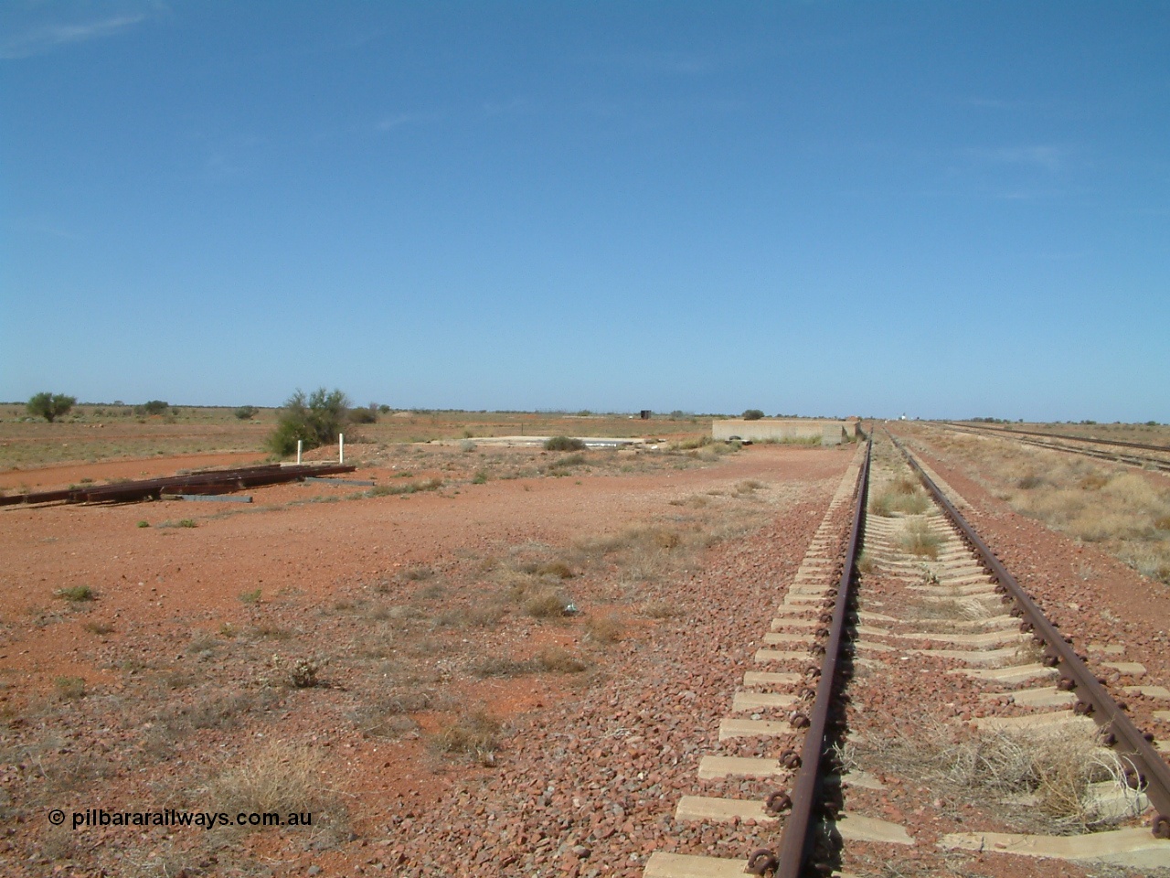 030416 110102
Manguri Siding, looking south along the third road or goods siding, loading platform, located 706.5 km from the 0 datum at Coonamia and 200 km north of Tarcoola between Wirrida and Cadney Park on the Tarcoola - Alice Springs line. [url=https://goo.gl/maps/y8coKnvDBraSuT8G7]GeoData location[/url]. 16th April 2003.

