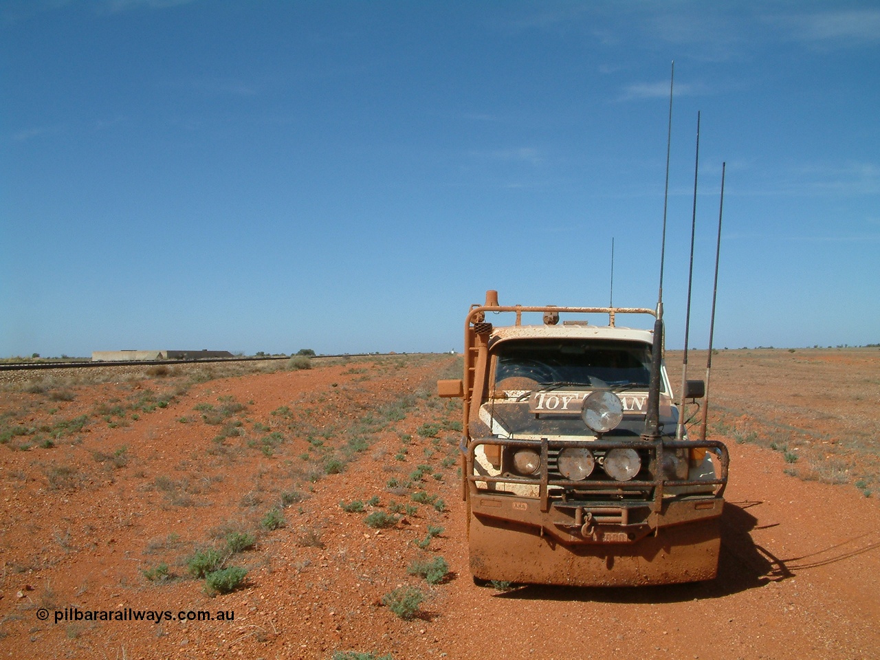 030416 110330
Here we are at a siding on the Tarcoola - Alice Springs railway line, Manguri which is 200 km north of Tarcoola and 40 km from Coober Pedy, loading platform on the left. As you can see the track was a bit wet. 16th April 2003. [url=https://goo.gl/maps/y8coKnvDBraSuT8G7]GeoData location[/url]. 16th April 2003.
